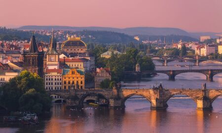 Scenic view of bridges (Charles bridge on foreground) on the Vltava river and of historical center of Prague in sunrise lightの写真素材