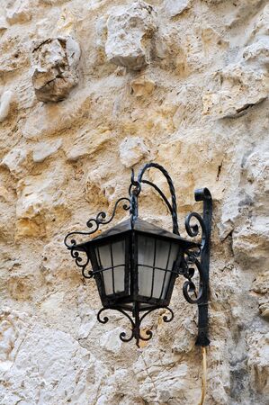 Retro lantern on old stone wall background, Antibes, French Riviera, Provence, Franceの写真素材