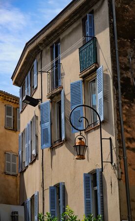 Retro lantern on wall of old building with shuttered windows in center of Antibes, French Riviera, Provence, Franceの写真素材