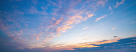 Beautiful clouds illuminated by sunrise. Sky background.の写真素材