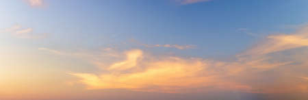 Light soft panorama sunset sky background with clouds illuminated by sun.の写真素材