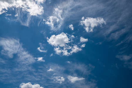Beautiful sky background with fluffy and cirrus clouds.