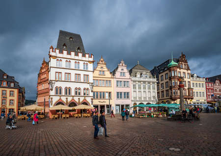 TRIER, GERMANY - OCTOBER 11, 2019: Colorful gothic houses under dramatic sky. Old Market square in Trier, Germany. Trier is a popular travel destination and UNESCO World Heritage Siteのeditorial素材