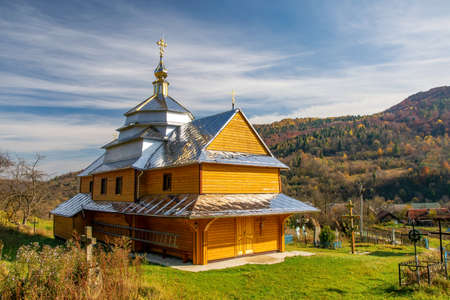 Scenic view of Greek Catholic wooden church of the Holy Trinity, Krushelnytsya, Lviv region, Ukraine at sunny autumn dayの写真素材