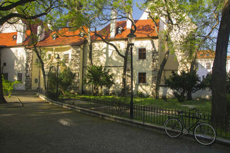 Old gothic church in sunlight on Suchona square at old citycenter of Bratislava, Slovakia with parked bicycle on foregroundの写真素材