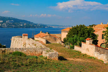 Tower and cannon of Fort Royal on Sainte-Marguerite Island. Stunning view on Cannes in opposite shore and vibrant water of Mediterranean sea. Lerins Islands, French Riviera, Franceの写真素材