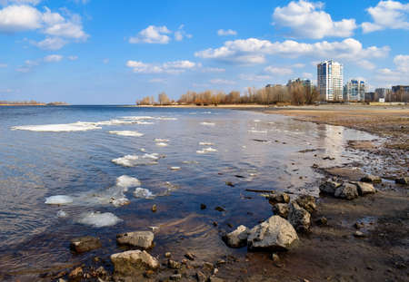 Ice drift on Dnieper river in Cherkasy city, Ukraine at sunny spring day. Picturesque fluffy cloudsの写真素材