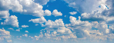 Beautiful background with picturesque white fluffy clouds in blue sky. banner sizeの写真素材