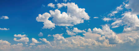 Beautiful background with picturesque white fluffy clouds in blue sky. banner sizeの写真素材