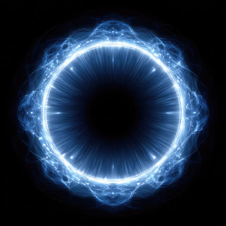 An illuminated circular design dominates the frame, showcasing vibrant blue energy radiating outwards. The visual elements include dynamic lines and an abstract representation of light against a dark backdrop. The composition suggests futuristic or scientific concepts suitable for visual communication or graphic design projects.の素材