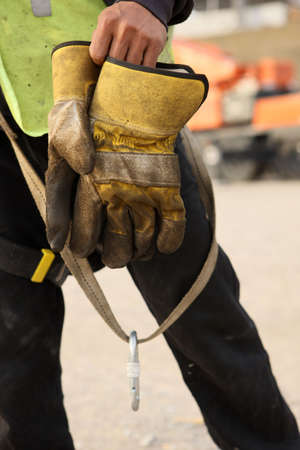 Construction Worker Takes Off Gloves After A Days Workの写真素材