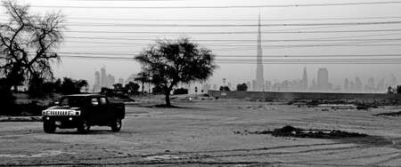 Off Road Vehicle Drives Away From The City Of Dubaiの写真素材