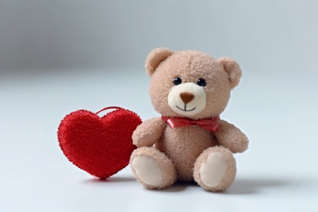 Teddy bear holding heart on a white background. Generative AIの素材