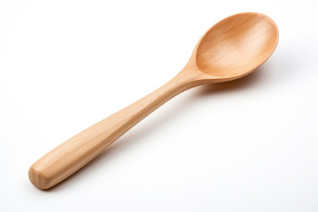 Wooden Spoon. A wooden spoon is placed neatly on a clean white background. The spoon is made of light-colored wood, with a smooth surface and a curved handle. on White or PNG Transparent Background.の素材