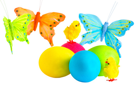 Easter eggs, petite chicks and  multicolored butterfly on a white backgroundの写真素材