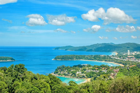 Landscape with turquoise sea, beaches, tropical greenery on the background of blue sky with white clouds. The view from the observation platform of the island of Phuket, Thailandの写真素材