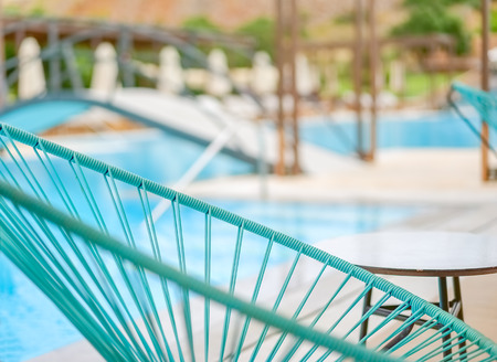 Blue chaise longue close up on a blurred pool background, Greeceの写真素材