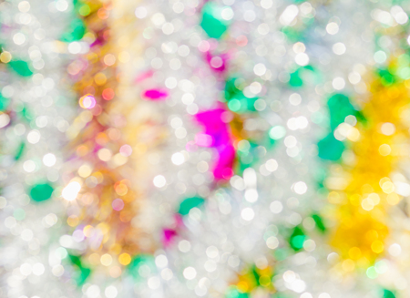 Yellow, purple, green and white festive bokeh. Abstract Christmas background の写真素材