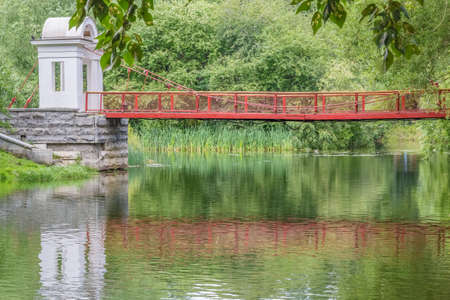 Picturesque landscape with suspension bridge in the park, close-up. Park of the Rastorguev-Kharitonov estate, Russia, Yekaterinburgの写真素材
