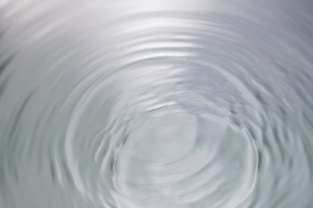 Water ripples on a white background with copy space. Abstract background
