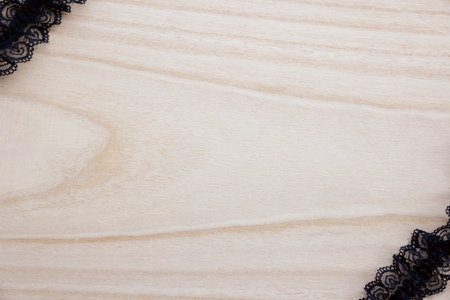 Black lace on a wooden background. Top view. Copy space.の写真素材