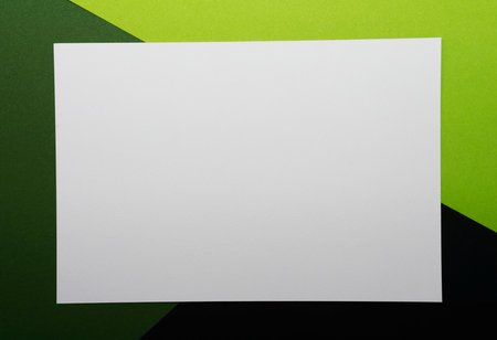 Blank white business card on green background.の写真素材