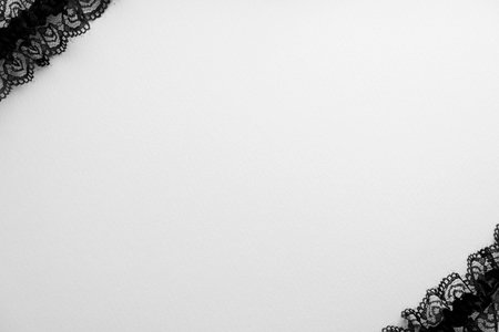 Black lace on a white background. Top view, copy space.の写真素材
