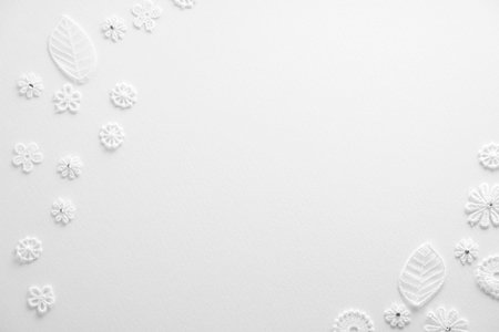 White paper snowflakes on white background.