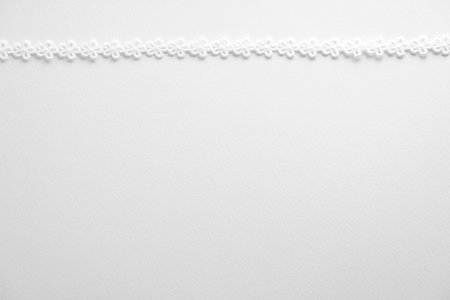 White lace on white background, top view. Space for text.の写真素材