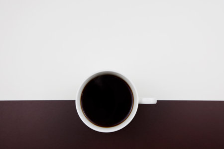 Coffee cup on white and brown background with copy space.の写真素材