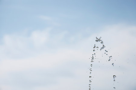 Water splash in the air with blue skyの写真素材