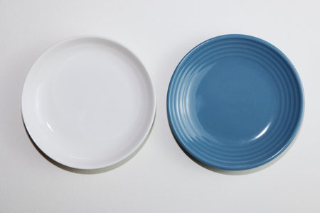 White and blue plates on a white background. View from above.の写真素材