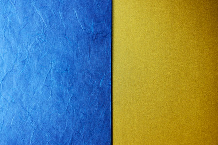 Blue and gold paper background with copy space for text or image.の写真素材