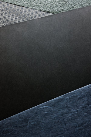 Black and navy paper background with copy space for text or image.