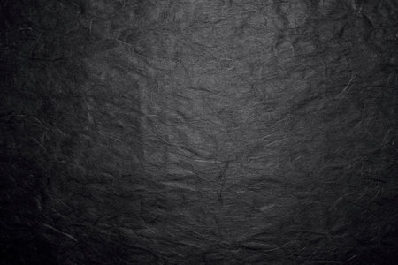 Crumpled black paper texture background for design with copy space for text or image.の写真素材