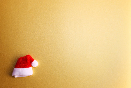 Santa Claus hat on golden background. Merry Christmas and Happy New Year.の写真素材