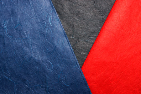 Red, blue and black paper background. Copy space for text.の写真素材