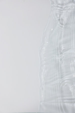 Water wave on white background, close-up of a water surfaceの写真素材