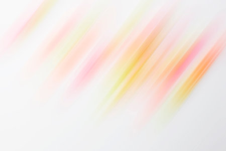 Abstract background with blurred pink and yellow diagonal stripes on white paper.