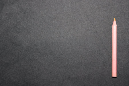 Pencil on black background with copy space for your text or design