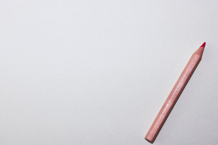 Red pencil on a white background. Top view. Copy space.の写真素材