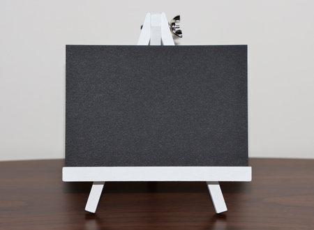 Black paper on wood table and white wall background.の写真素材