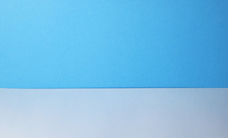 Blue paper on blue wall background for product display.の写真素材