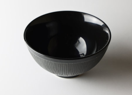 Black bowl on white background, close-up, side view.の写真素材