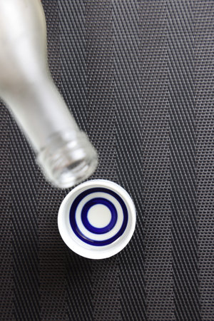 Top view of a bottle of champagne on a carbon fiber background.の写真素材