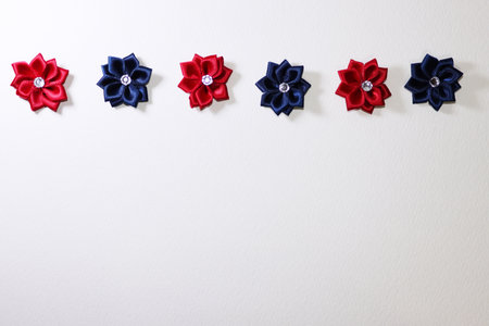 Red and blue decorated flowers on white paper with copy space