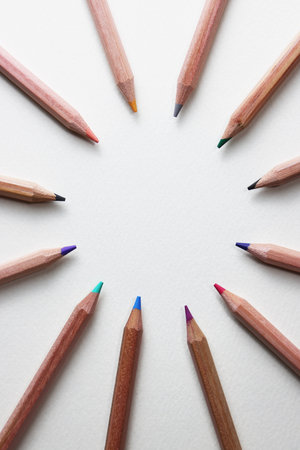 Colored pencils arranged in a circle on a white background.の写真素材
