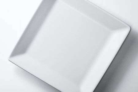 White square plate on a white background. Top view. Copy space.