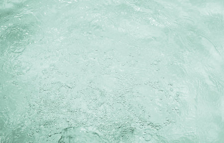 Water surface with bubbles and drops. Turquoise water background.