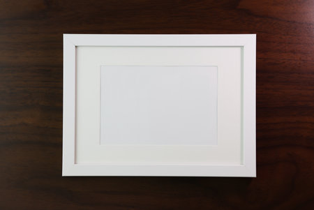 White picture frame on wooden background. Copy space for your text.の写真素材